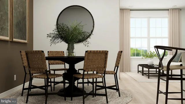 a view of a dining room with furniture and a potted plant