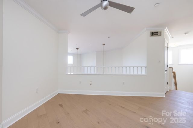 an empty room with a white cabinet and a window