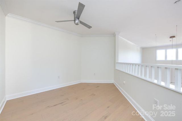 a view of a hallway with a ceiling fan