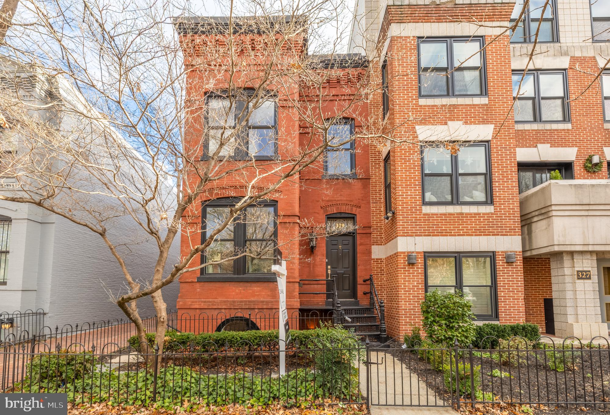 329 8th Street Northeast Washington, DC 20002 - Photo 2 of 51 front view of a brick house with a small yard and plants