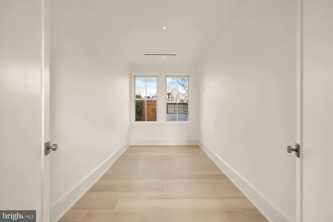 a hallway with white cabinets