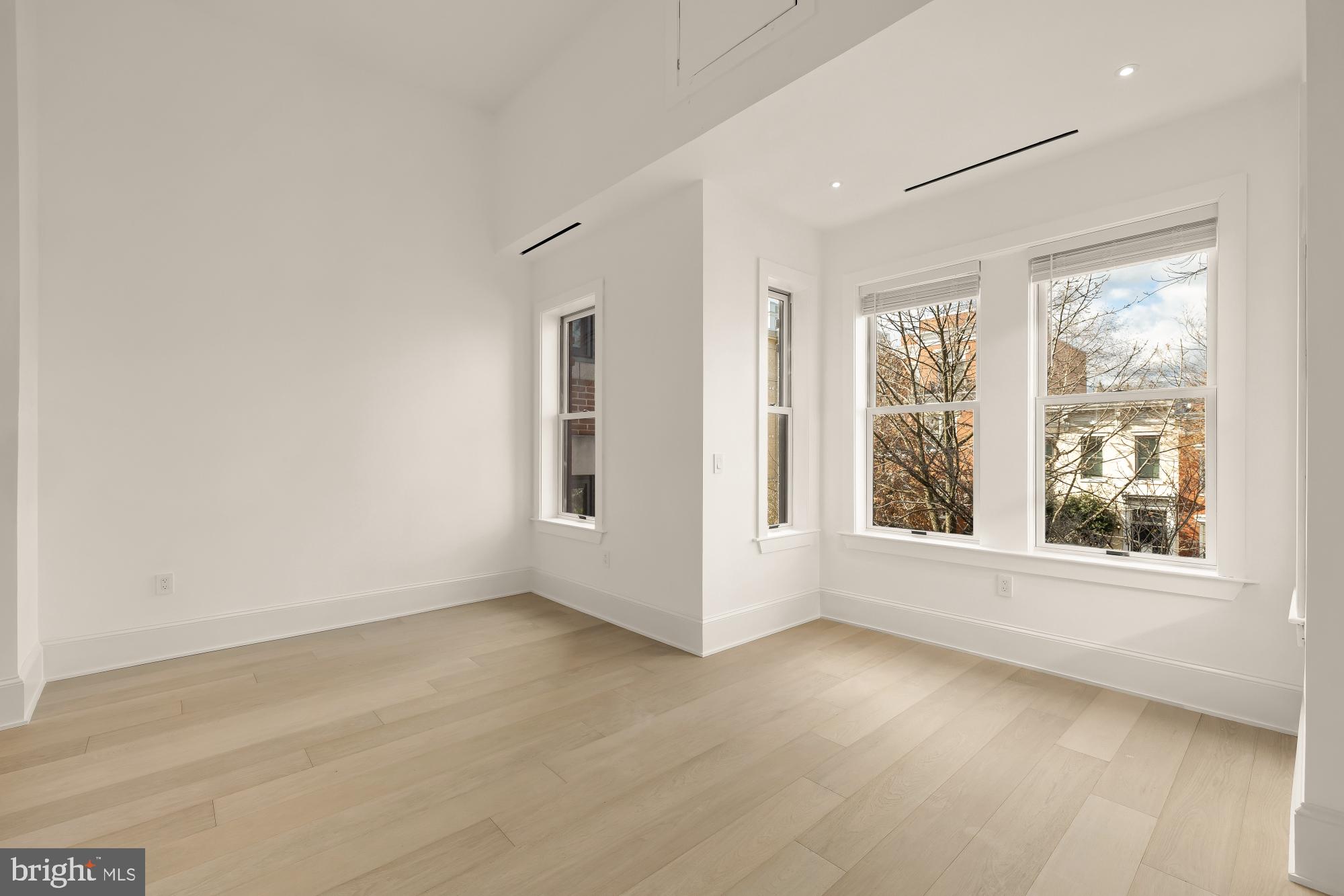329 8th Street Northeast Washington, DC 20002 - Photo 29 of 51 an empty room with wooden floor and windows