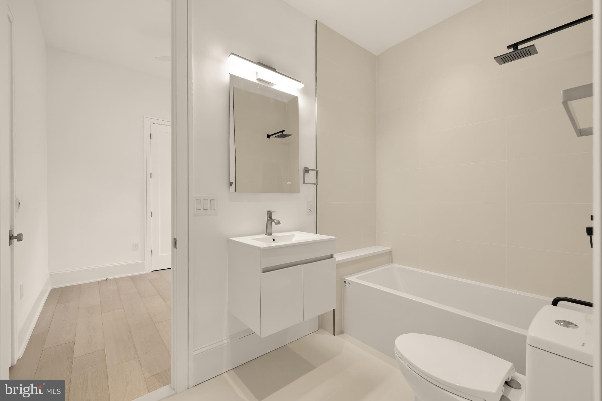 329 8th Street Northeast Washington, DC 20002 - Photo 35 of 51 a bathroom with a sink a toilet and shower