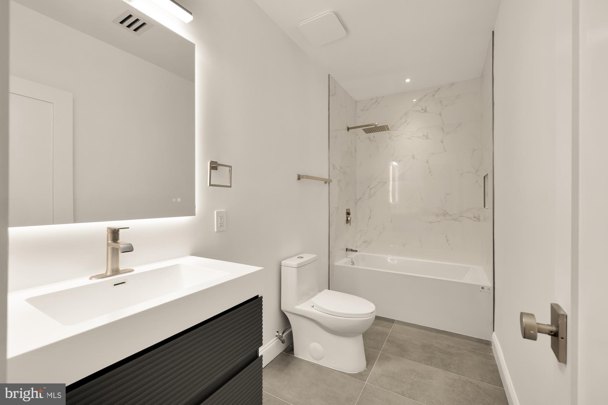 329 8th Street Northeast Washington, DC 20002 - Photo 46 of 51 a bathroom with a sink mirror toilet and bathtub