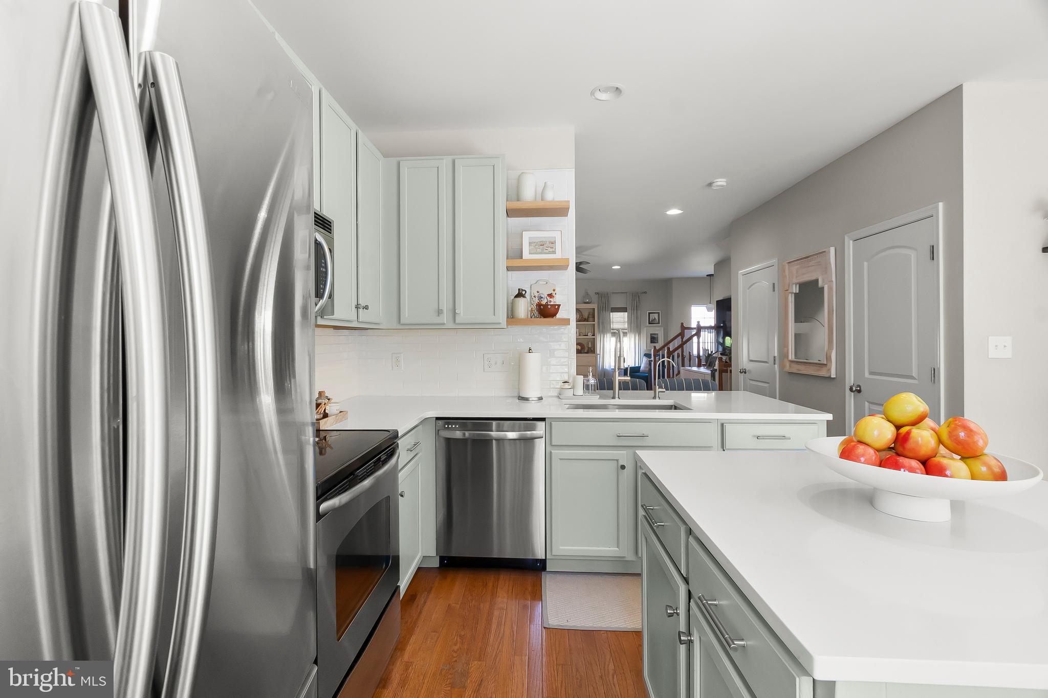 527 Jacobsen Drive Newark, DE 19702 - Photo 20 of 60 a kitchen with stainless steel appliances granite countertop a refrigerator a sink dishwasher a stove and white countertops with wooden floor