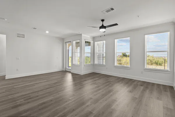 a view of kitchen with refrigerator microwave and stove