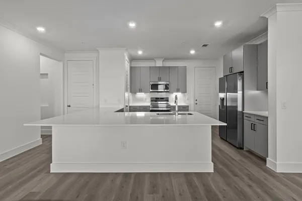 a large kitchen with stainless steel appliances and a refrigerator
