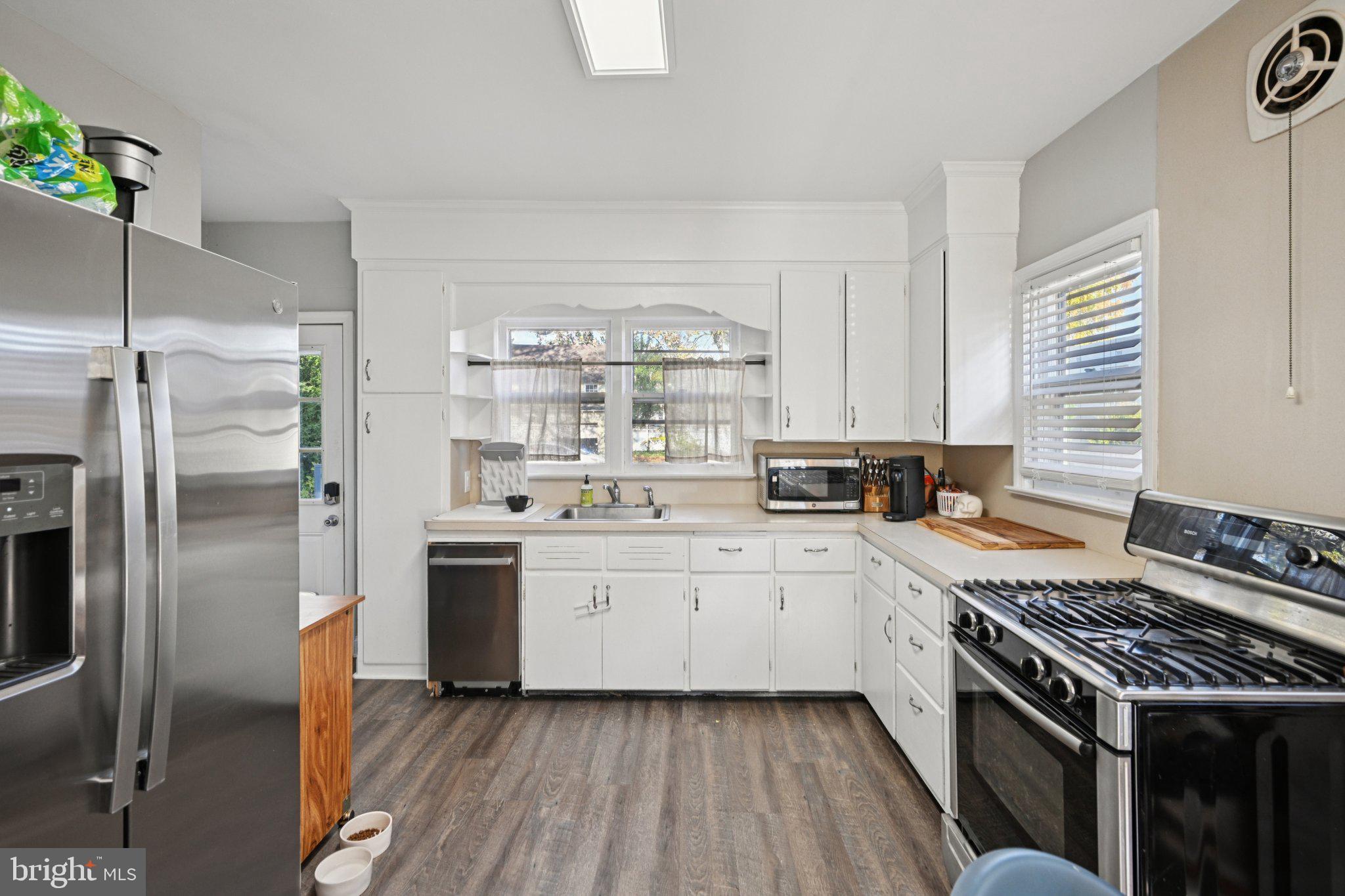 127 7th Avenue Haddon Heights, NJ 08035 - Photo 14 of 47 a kitchen with stainless steel appliances a stove a sink and a refrigerator