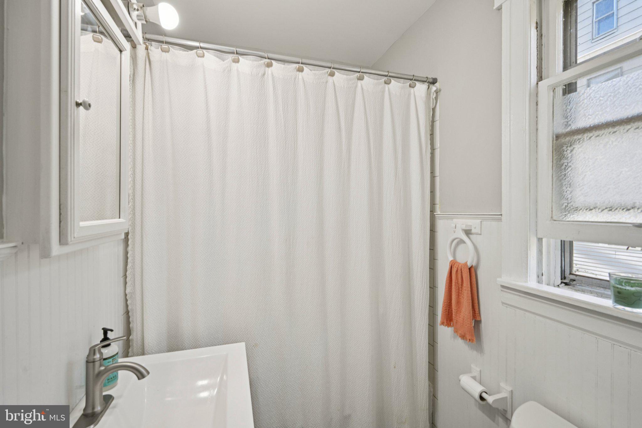 127 7th Avenue Haddon Heights, NJ 08035 - Photo 18 of 47 a bathroom with a shower curtain and a sink