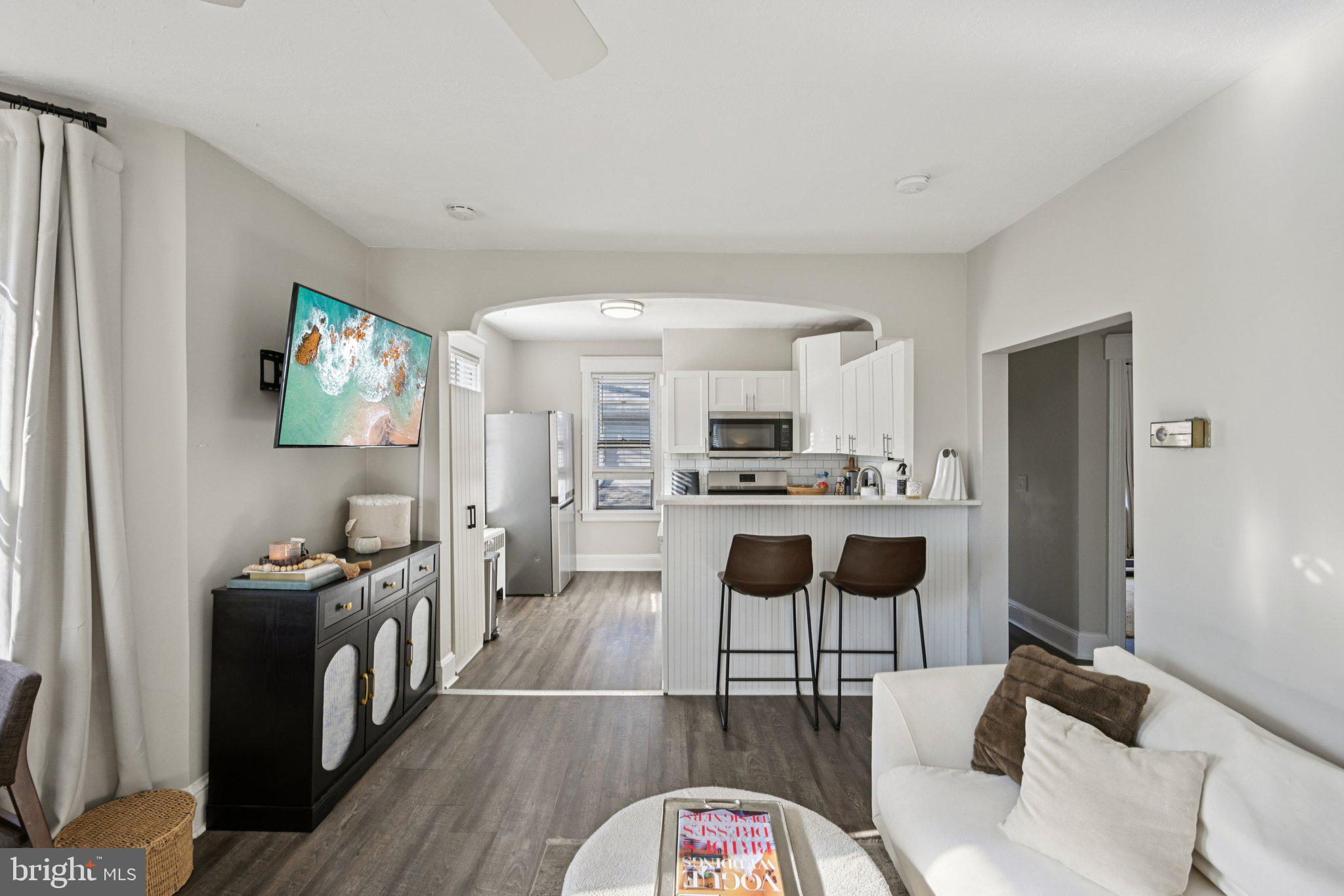 127 7th Avenue Haddon Heights, NJ 08035 - Photo 26 of 47 a kitchen with stainless steel appliances kitchen island granite countertop a refrigerator a stove top oven a sink dishwasher and white cabinets with wooden floor