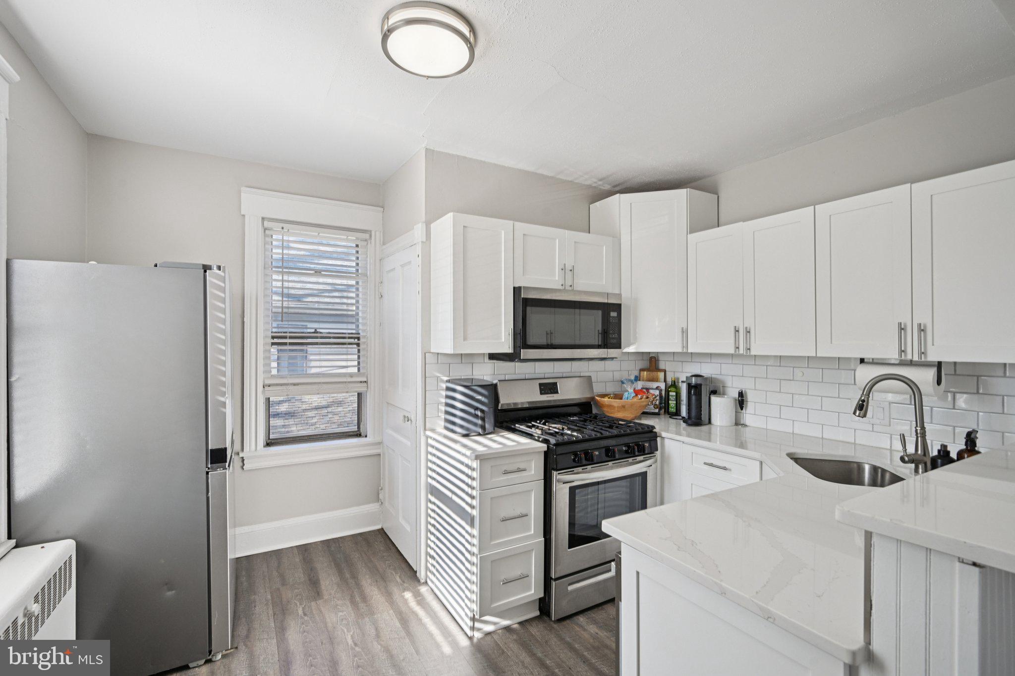 127 7th Avenue Haddon Heights, NJ 08035 - Photo 28 of 47 a kitchen with granite countertop a sink stainless steel appliances and cabinets