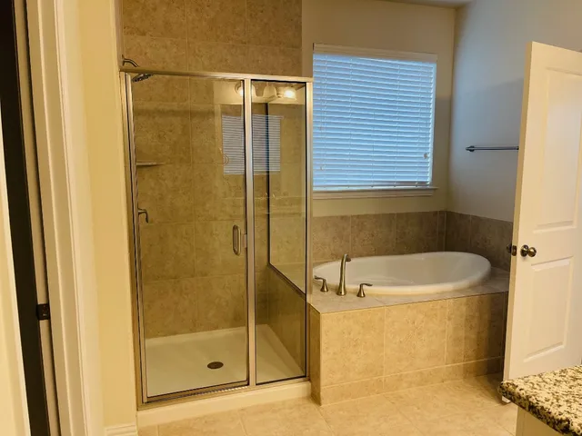 a bathroom with a bathtub and a shower