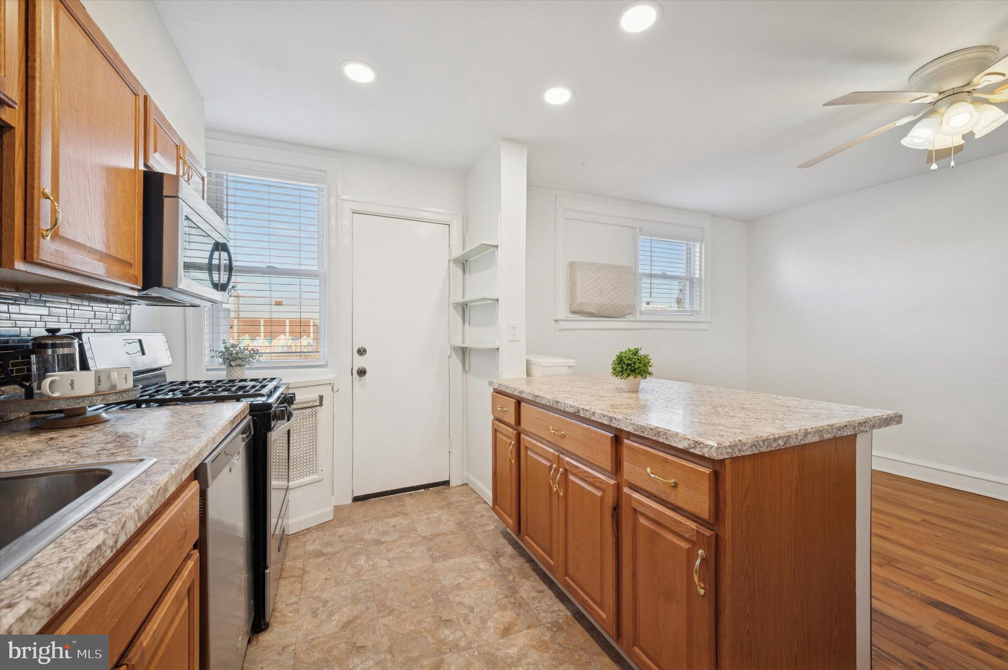 6207 Homer Street Philadelphia, PA 19144 - Photo 13 of 26 a kitchen with stainless steel appliances granite countertop a sink stove and refrigerator