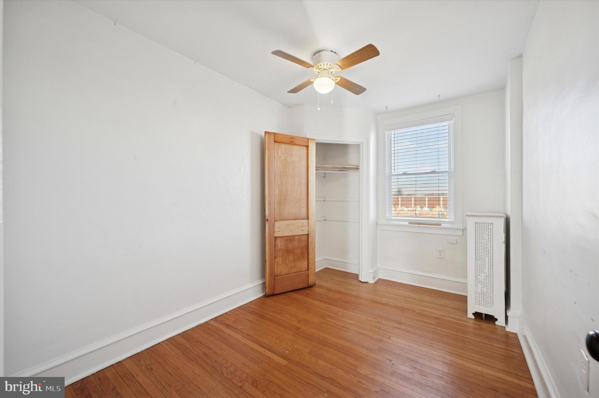 6207 Homer Street Philadelphia, PA 19144 - Photo 20 of 26 an empty room with wooden floor ceiling fan and window