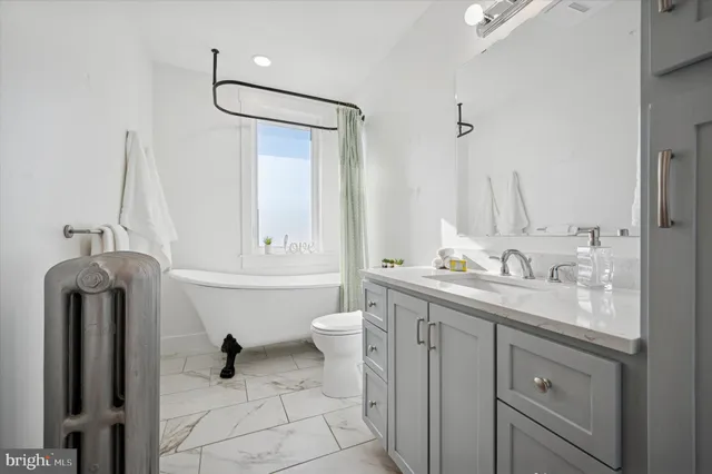 a white bath tub sitting next to a white toilet