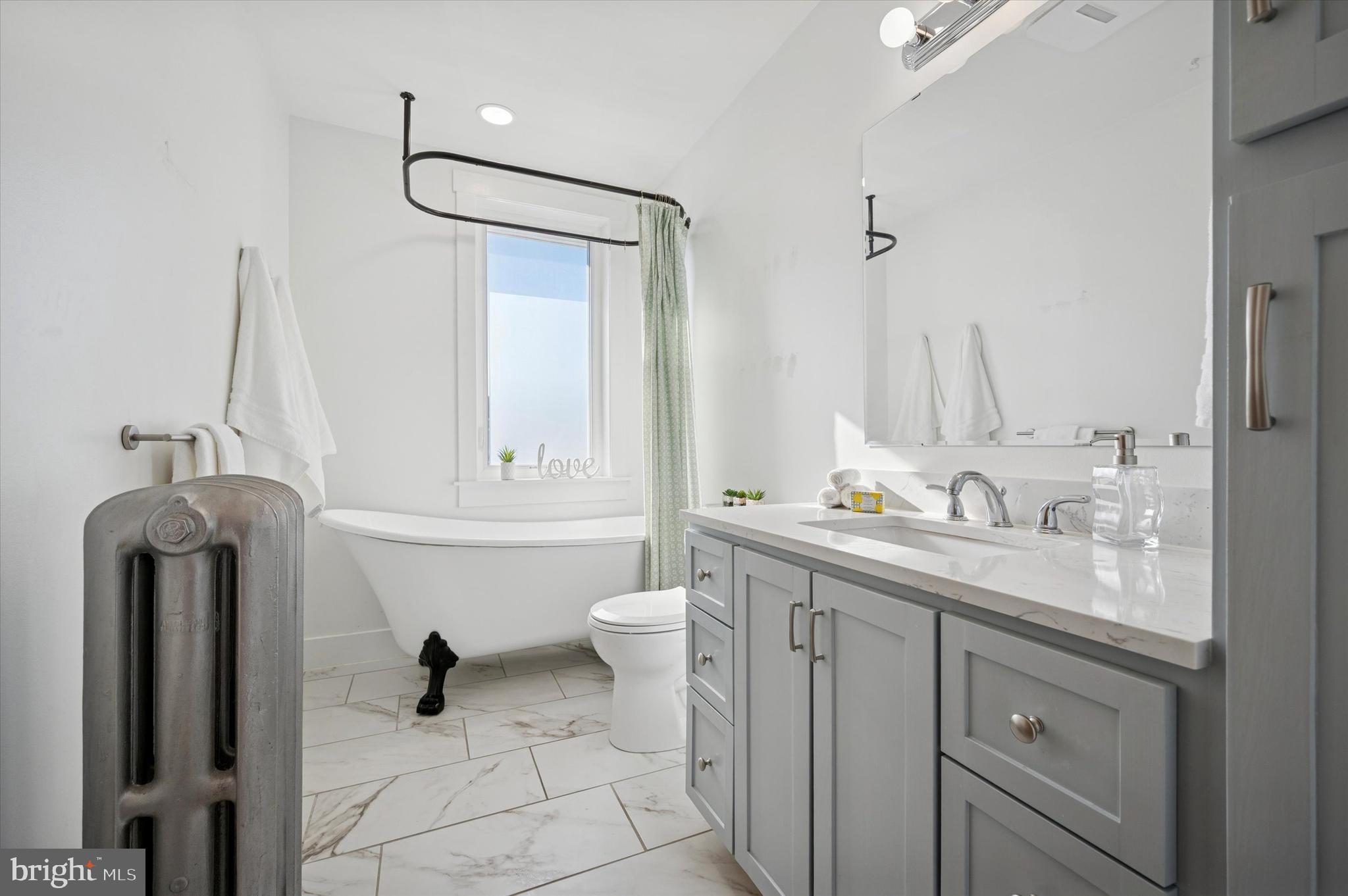 6207 Homer Street Philadelphia, PA 19144 - Photo 22 of 26 a bathroom with a sink a toilet and a mirror