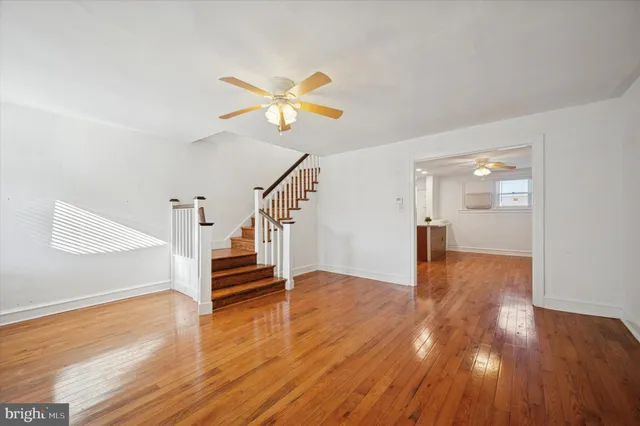 a view of entryway with wooden floor and stairs
