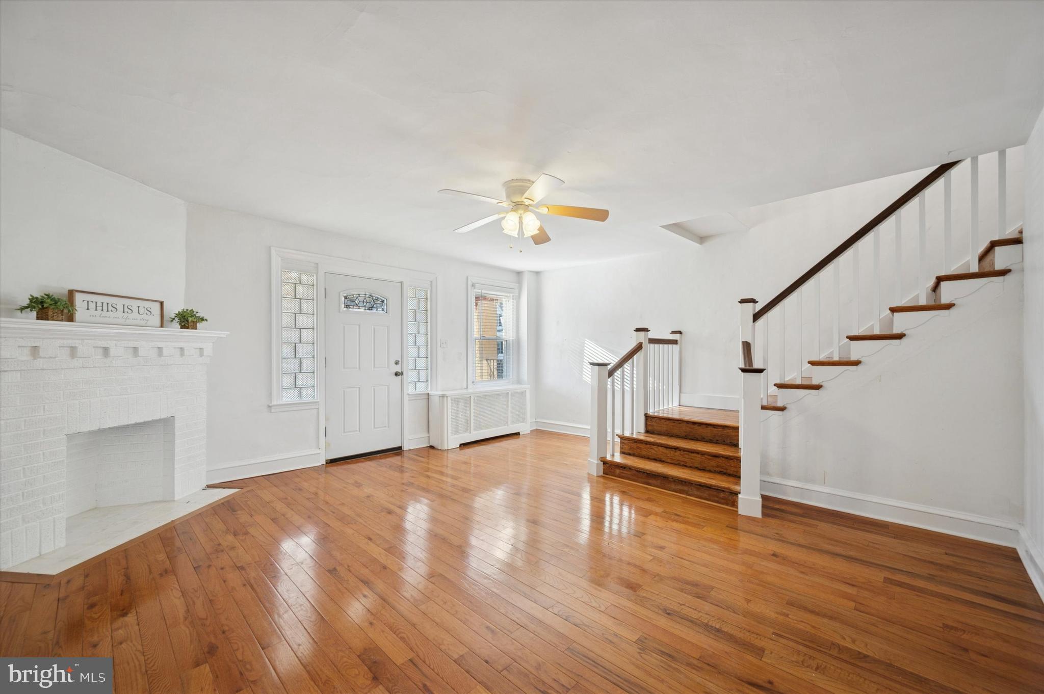 6207 Homer Street Philadelphia, PA 19144 - Photo 5 of 26 a view of an empty room with wooden floor fireplace and a window