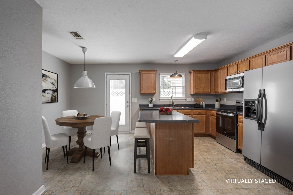 2042 Shaylin Loop Antioch, TN 37013 - Photo 11 of 54 a kitchen with refrigerator and chairs