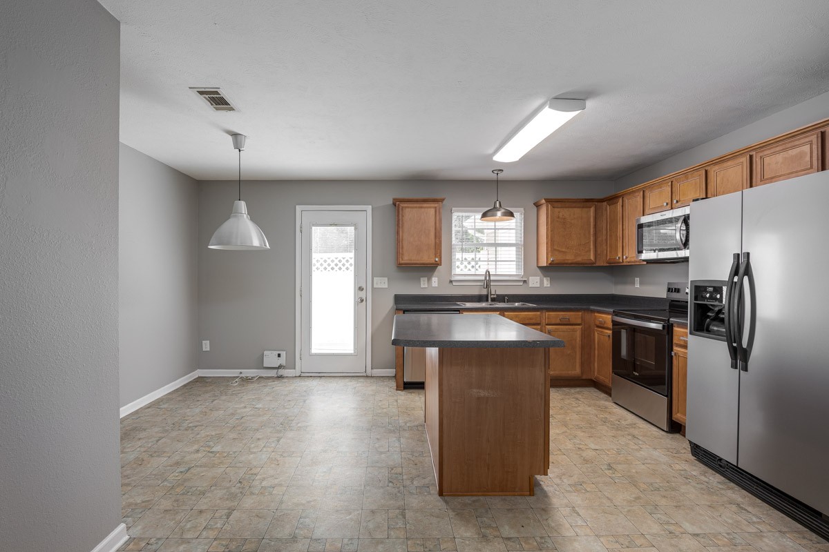 2042 Shaylin Loop Antioch, TN 37013 - Photo 12 of 54 a kitchen with stainless steel appliances granite countertop a refrigerator and a stove