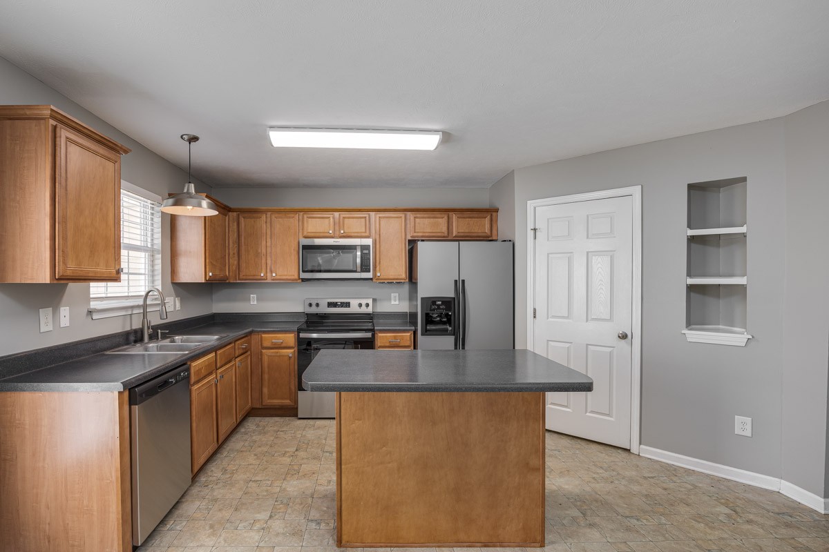 2042 Shaylin Loop Antioch, TN 37013 - Photo 13 of 54 a kitchen with stainless steel appliances granite countertop a sink stove and refrigerator