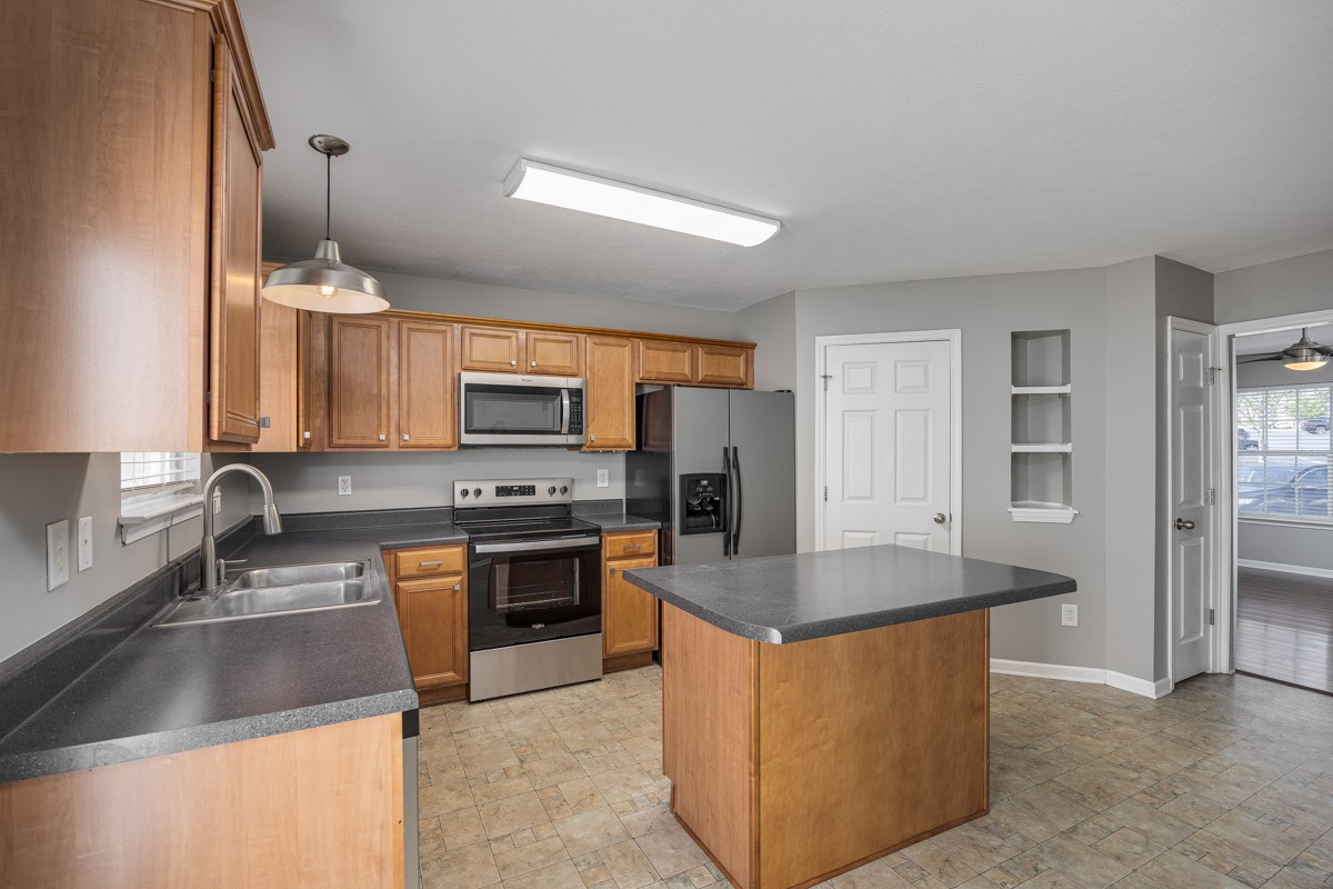 2042 Shaylin Loop Antioch, TN 37013 - Photo 14 of 54 a kitchen with stainless steel appliances granite countertop a sink stove and refrigerator