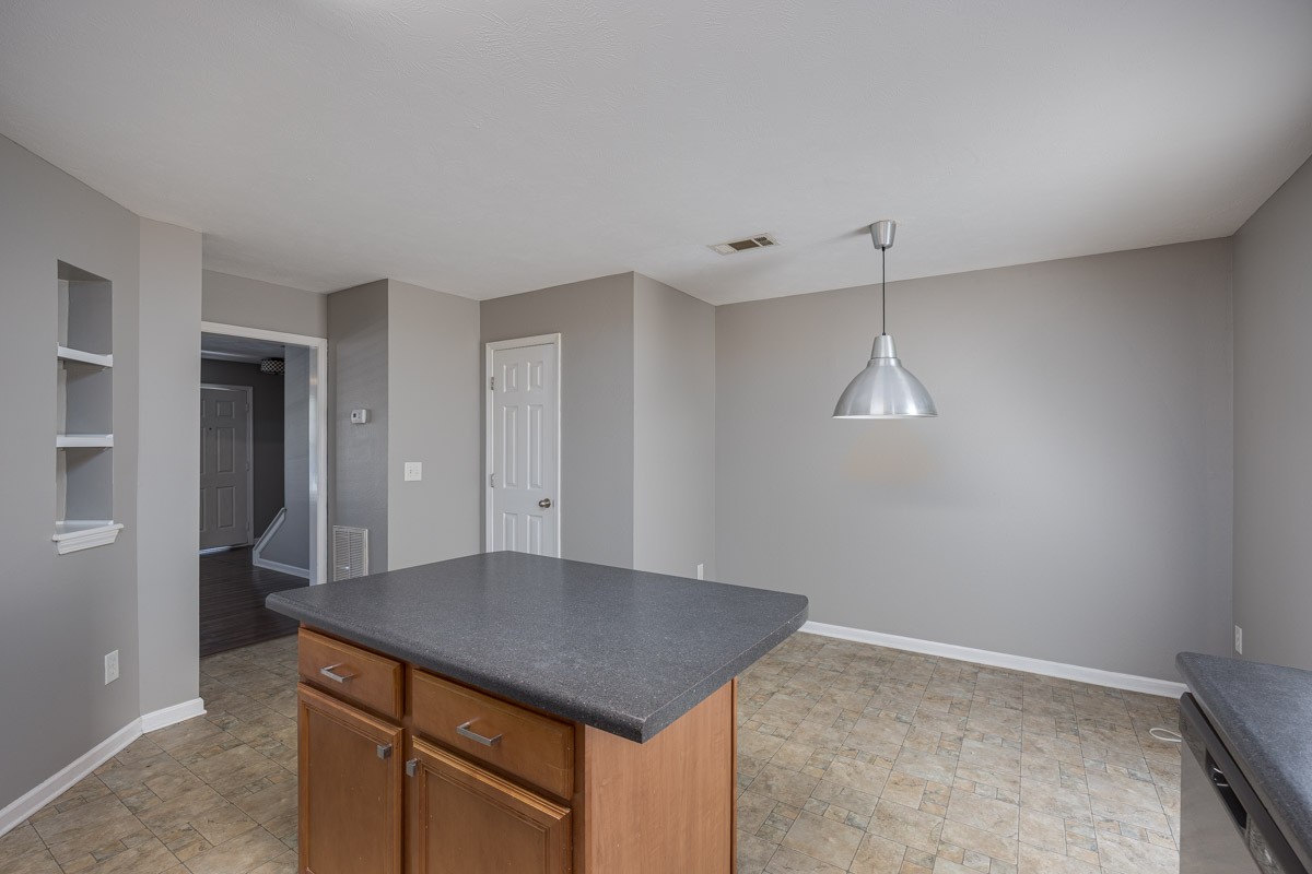 2042 Shaylin Loop Antioch, TN 37013 - Photo 16 of 54 wooden floor in an empty room with a kitchen