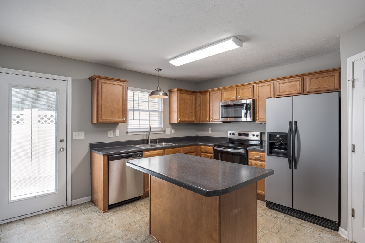 2042 Shaylin Loop Antioch, TN 37013 - Photo 18 of 54 a kitchen with stainless steel appliances granite countertop a refrigerator a sink a stove a microwave and island