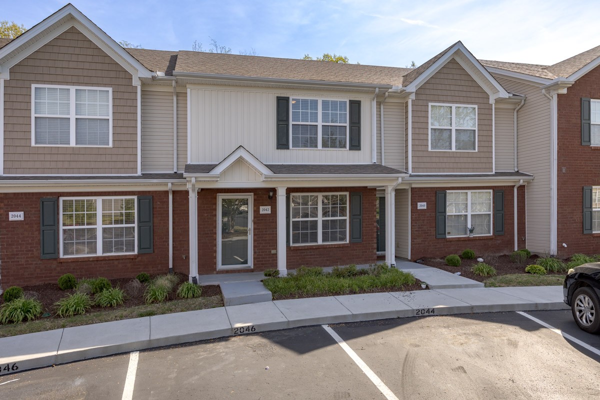 2042 Shaylin Loop Antioch, TN 37013 - Photo 50 of 54 a front view of a house with a yard and potted plants