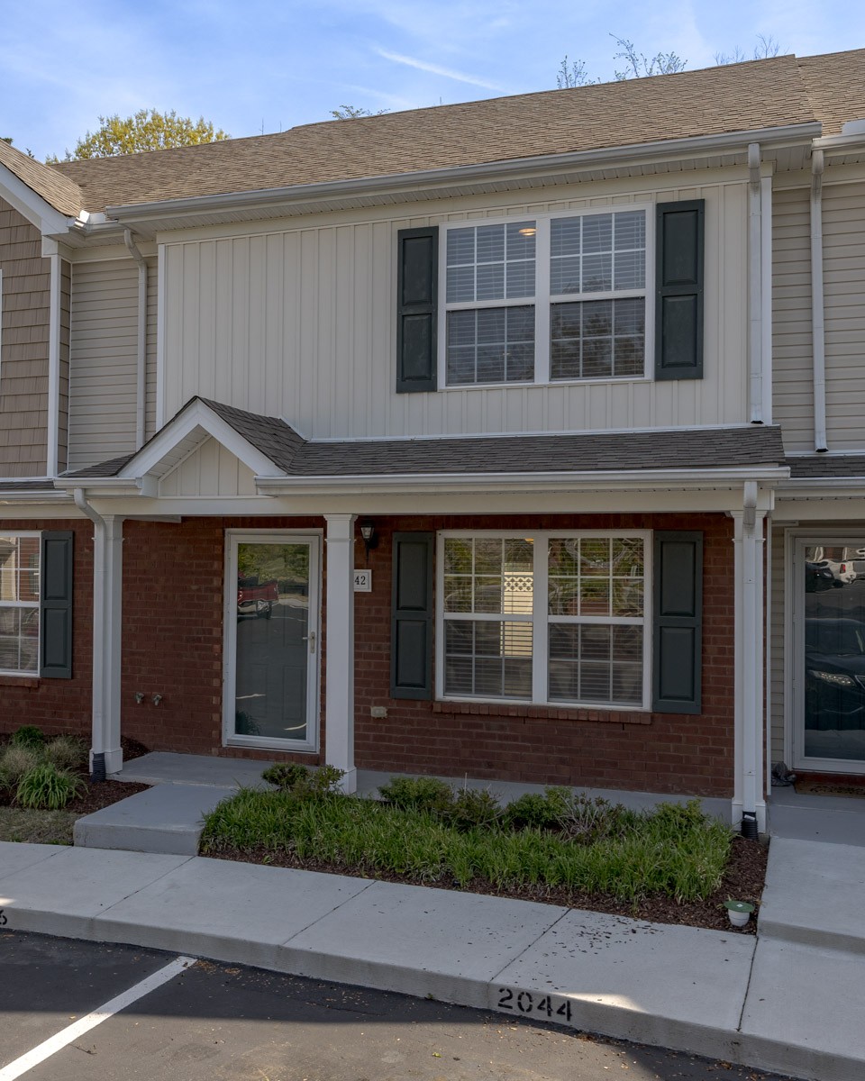 2042 Shaylin Loop Antioch, TN 37013 - Photo 52 of 54 a view of a brick house with a yard and large windows