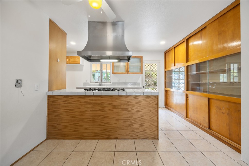 101 Hampden Terrace Alhambra, CA 91801 - Photo 12 of 46 a view of open kitchen with granite countertop a sink and a stove next to a large window
