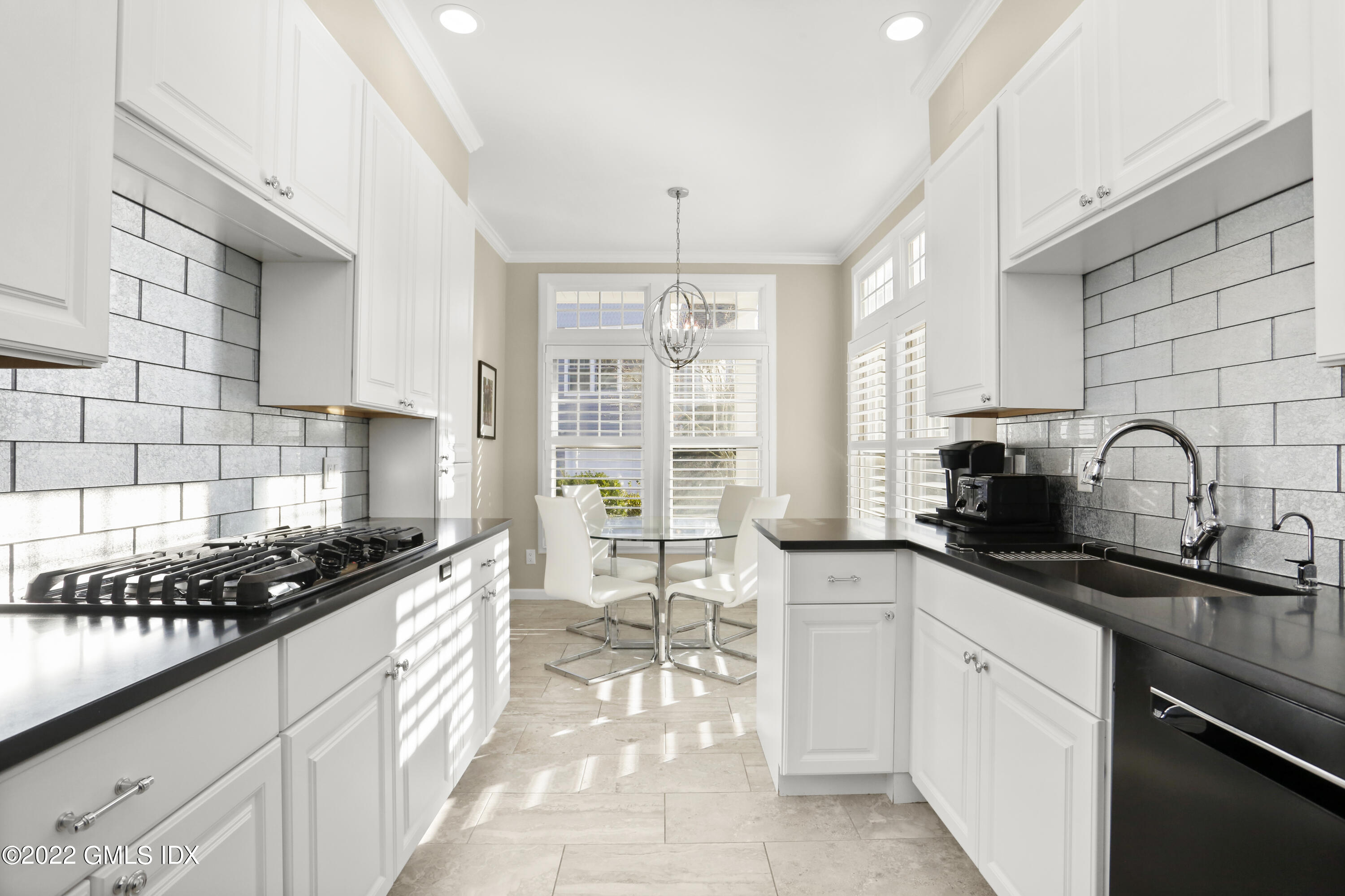 186 Field Point Road, Unit 6A Greenwich, CT 06830 - Photo 4 of 25 a kitchen with granite countertop a sink stove and cabinets