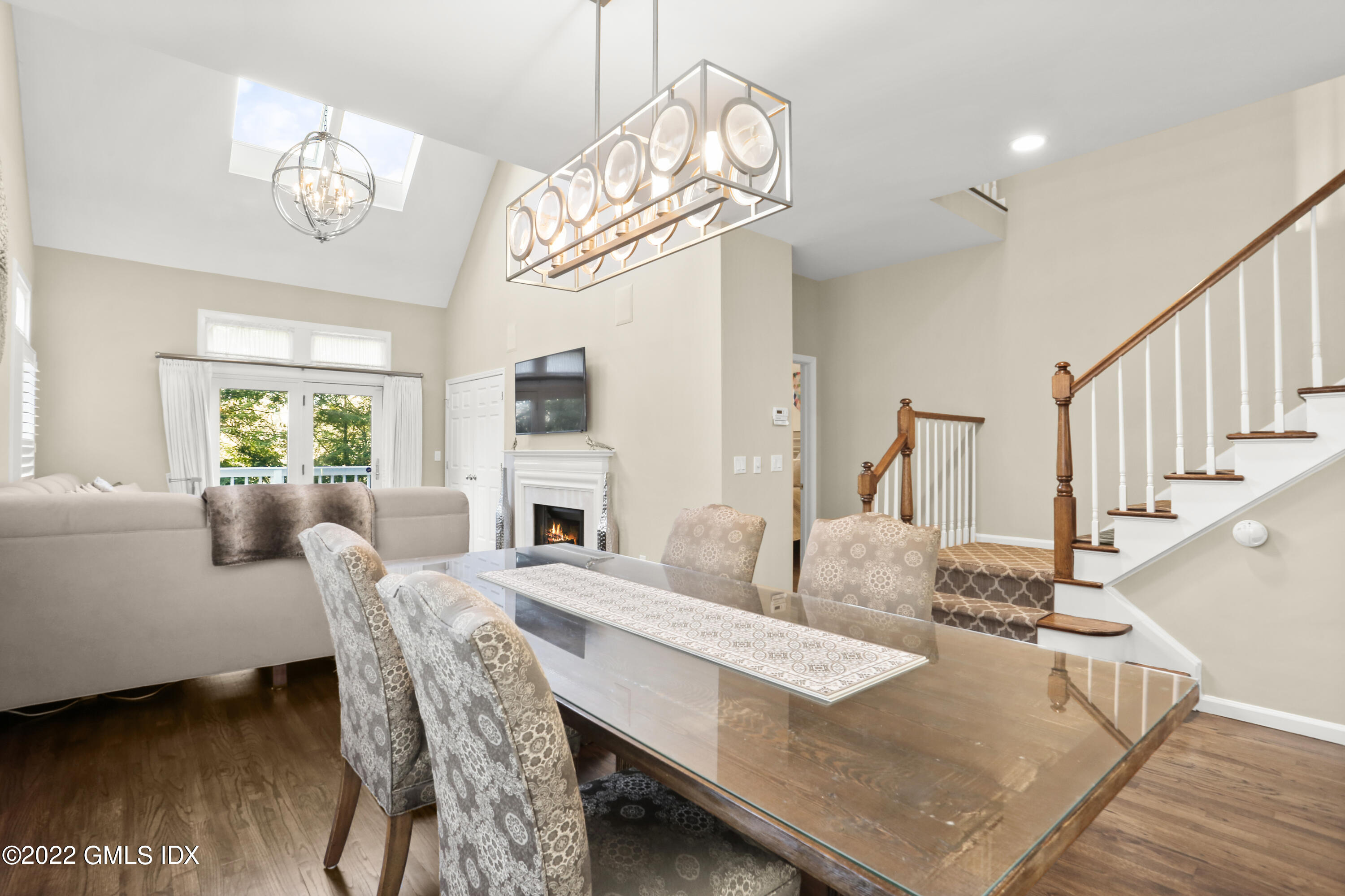 186 Field Point Road, Unit 6A Greenwich, CT 06830 - Photo 5 of 25 a view of a dining room with furniture and wooden floor