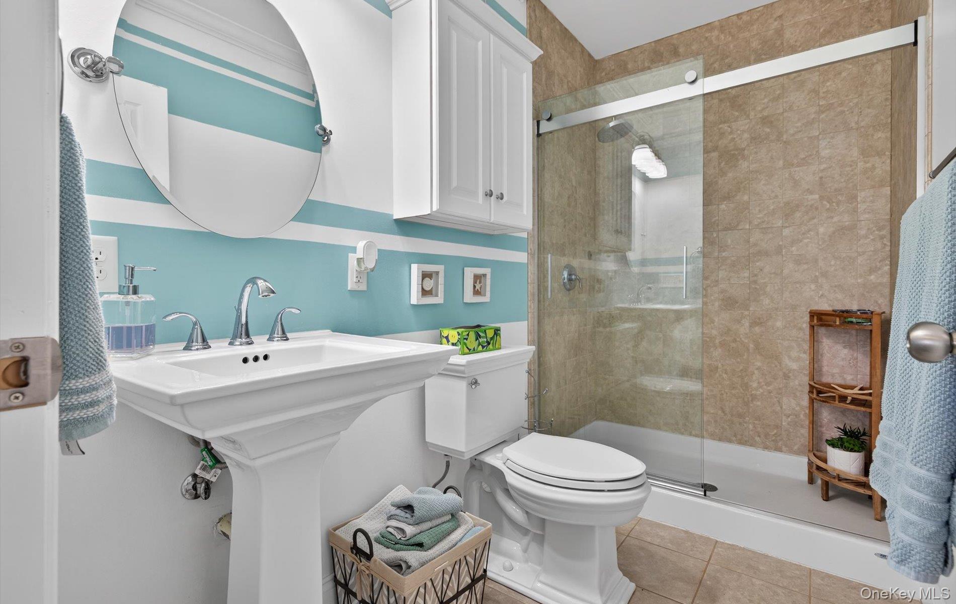 108 Awixa Avenue Bay Shore, NY 11706 - Photo 24 of 47 Full bathroom with a stall shower and light tile patterned floors