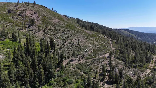 a view of a large building with mountains in the background