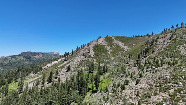a view of a large building with mountains in the background