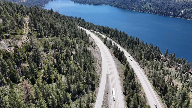 a view of a yard with wooden fence