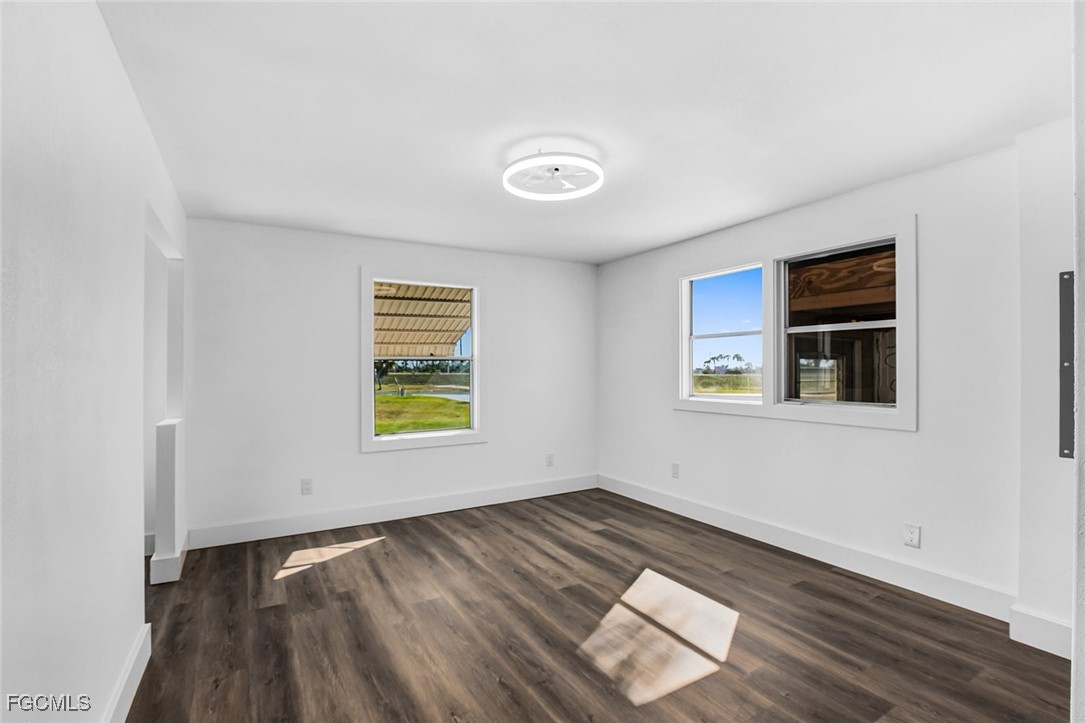 13651 Grackle Road Fort Myers, FL 33908 - Photo 26 of 43 an empty room with wooden floor and windows