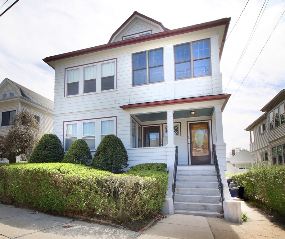 58-60 Matignon Road Cambridge, MA 02140 - Photo 15 of 16 a front view of a house with a yard