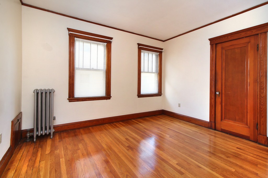 58-60 Matignon Road Cambridge, MA 02140 - Photo 6 of 16 an empty room with wooden floor and windows
