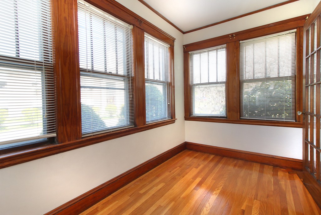 58-60 Matignon Road Cambridge, MA 02140 - Photo 7 of 16 a view of an empty room with wooden floor and a window