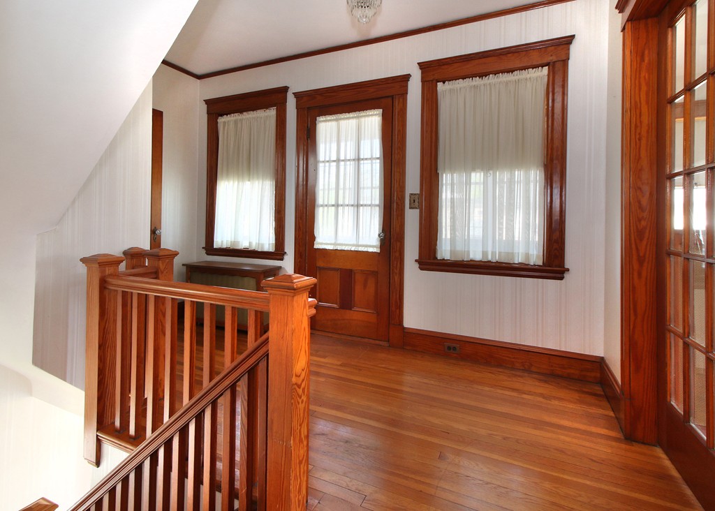 58-60 Matignon Road Cambridge, MA 02140 - Photo 8 of 16 a view of an empty room with wooden floor and a window