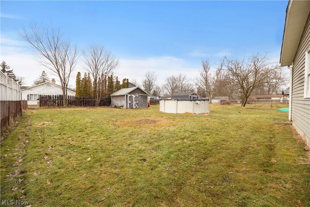 12452 Island Road Grafton, OH 44044 - Photo 30 of 39 Fenced backyard featuring a storage unit