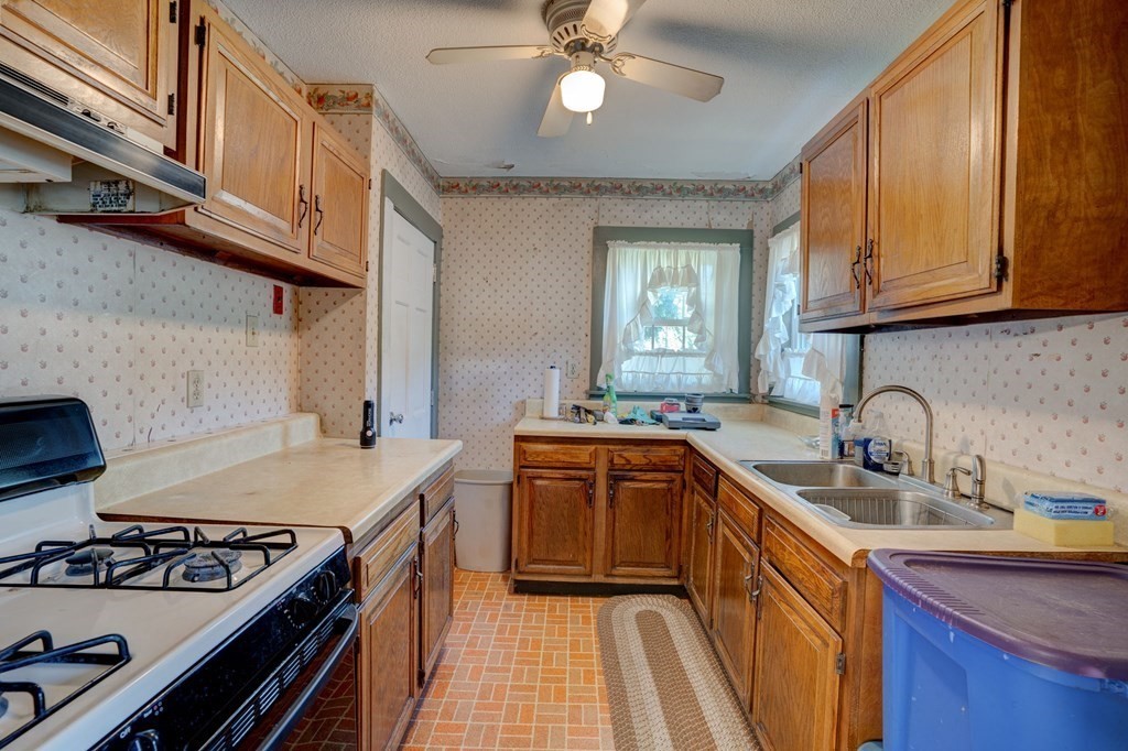 210 Belchertown Road Ware, MA 01082 - Photo 19 of 25 a kitchen with stainless steel appliances granite countertop a sink a stove and a wooden cabinets
