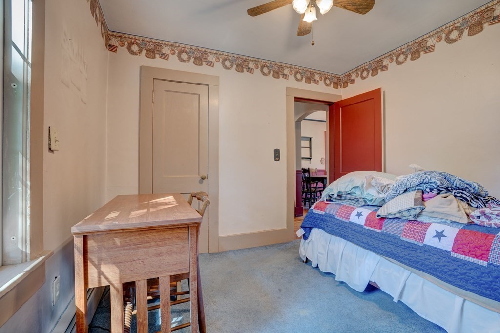 210 Belchertown Road Ware, MA 01082 - Photo 24 of 25 a bedroom with a bed and a chandelier