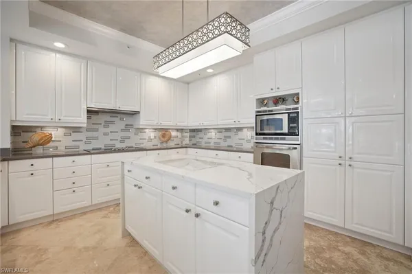 a kitchen with granite countertop cabinets and appliances