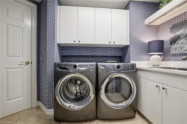 a close view of a utility room with dryer and washer