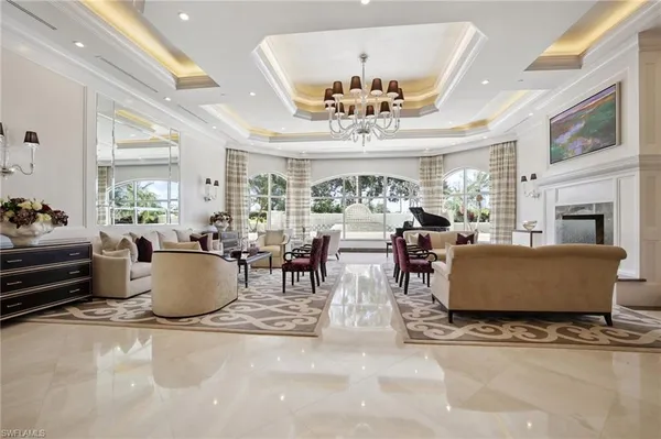a living room with furniture and a chandelier