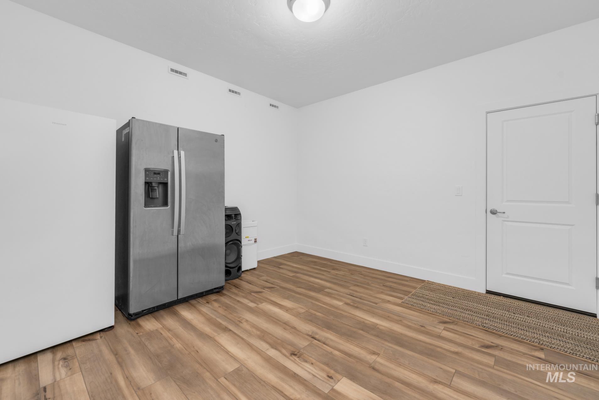 20430 Pitkin Way Caldwell, ID 83605 - Photo 13 of 23 Empty room featuring light wood finished floors