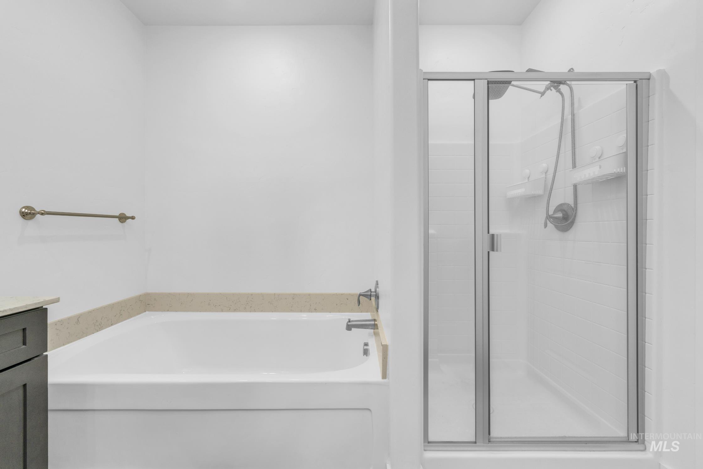 20430 Pitkin Way Caldwell, ID 83605 - Photo 14 of 23 Full bath featuring a bath, a shower stall, and vanity